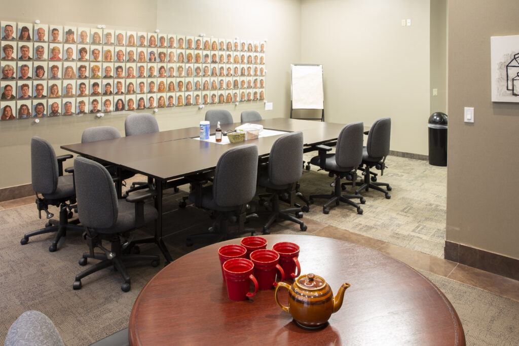 Photo of the GCF Community Room, chairs table in a board room with a side table for refreshments