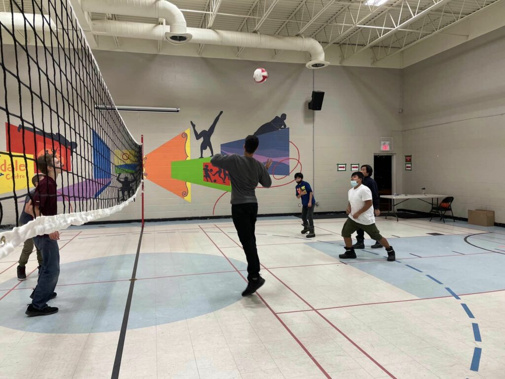 Youth participants of the Shelldale Family Gateway Volleyball Program watch a volleyball flying through the air.