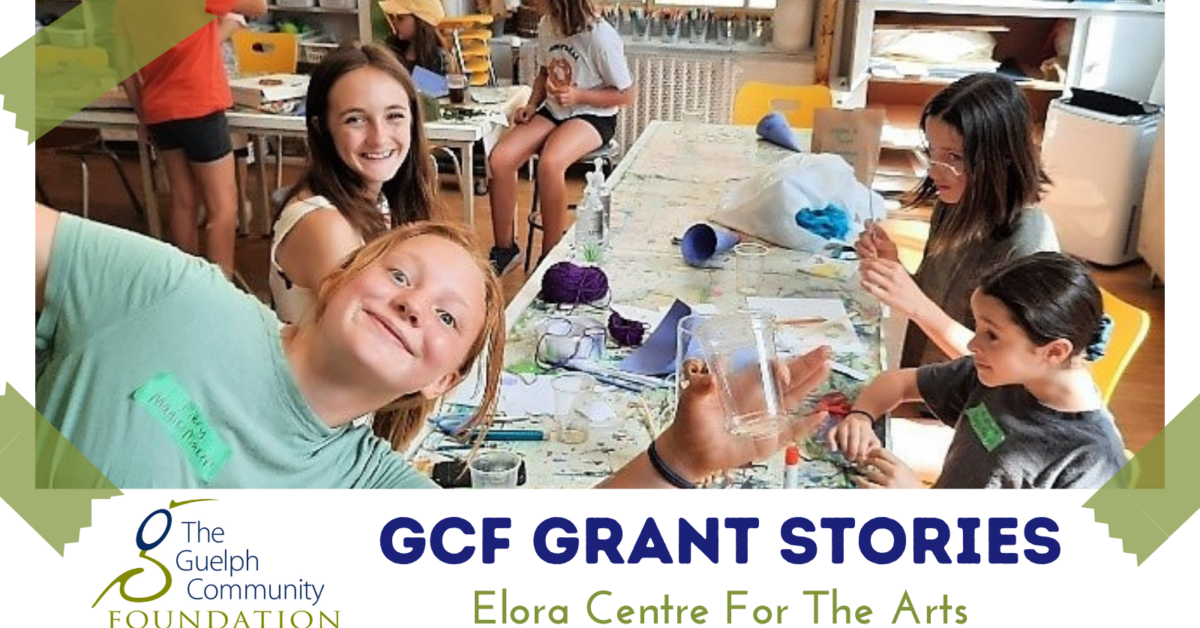GCF Grant Stories Elora Centre For The Arts: Photo of four + children smiling in a busy craft area holding craft supplies