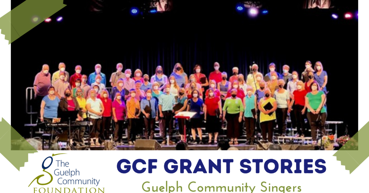 GCF Grant Stories Guelph Community Singers: photo of three rows of colourful masked choir performers on a stage