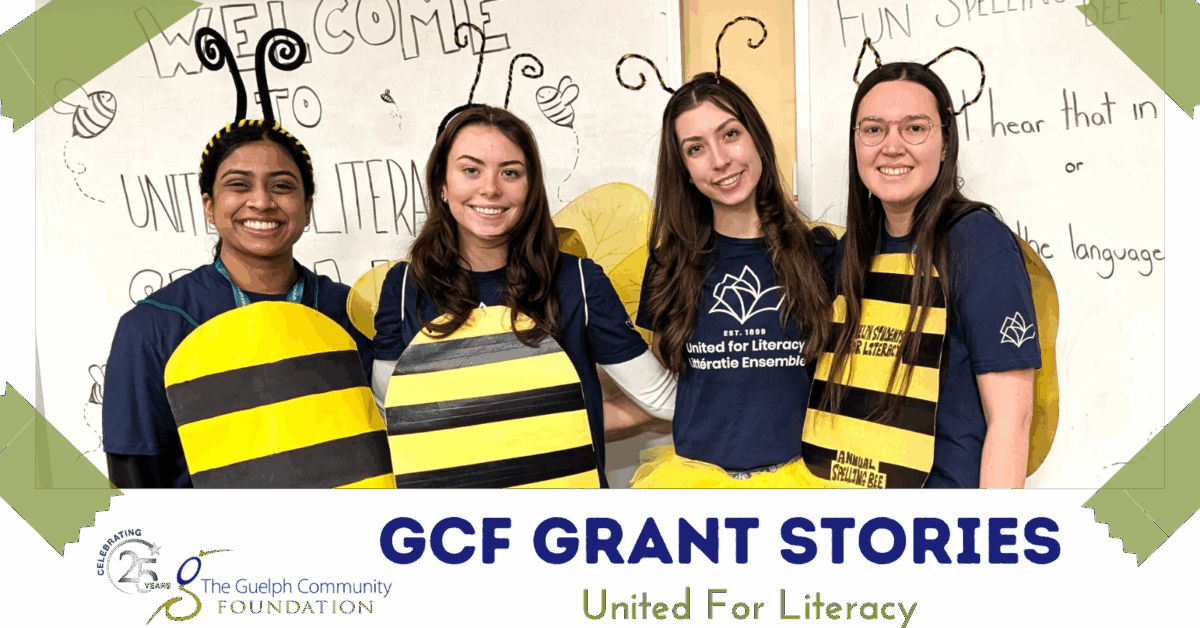 Four smiling women dressed as bees standing in front of a whiteboard with welcome messages. They are part of the United for Literacy program supported by a GCF grant.