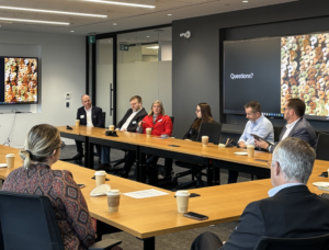 Photo of formally dressed people chatting in a circle in a board room