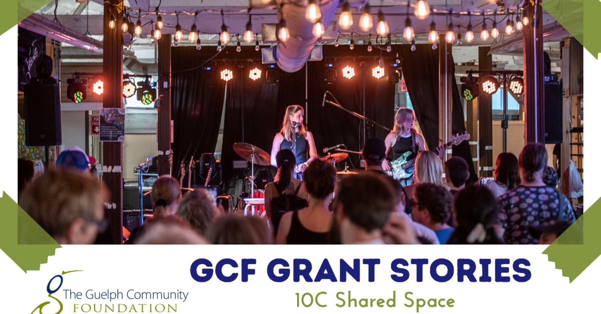 Evening concert scene featuring a female singer and guitarist entertaining a diverse audience under warm lighting. GCF Grant Stories for 10C Shared Space.