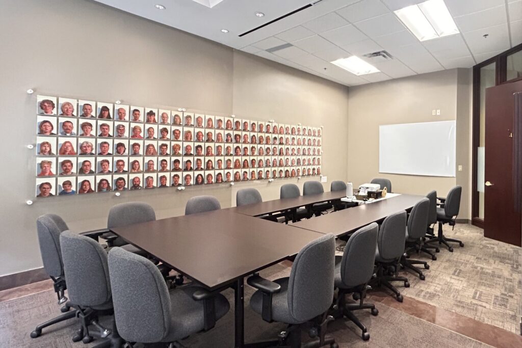 Photo of the GCF Community Room, chairs, table, and whiteboard in a board room.