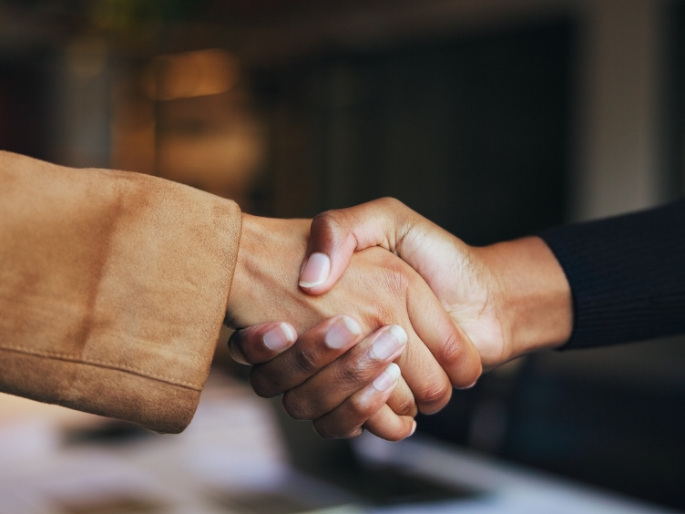 A handshake between 2 people
