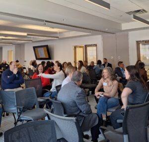 Attendees participate in a small-group conversation during an interactive networking activity at the Finding Abundance symposium.