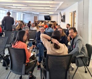 Attendees participate in a small-group conversation during an interactive networking activity at the Finding Abundance symposium.