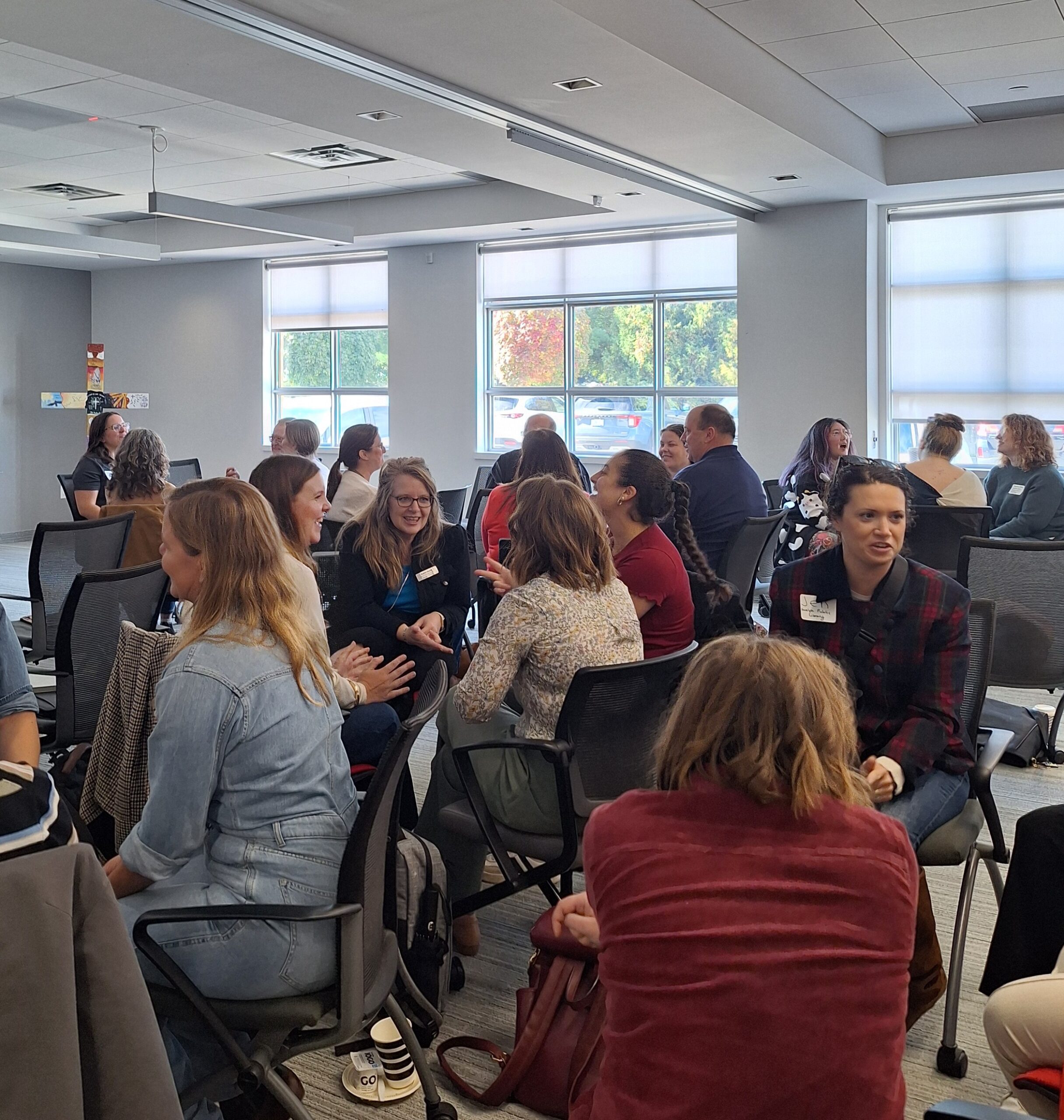 Attendees participate in a small-group conversation during an interactive networking activity at the Finding Abundance symposium.