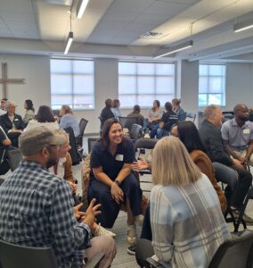 Attendees participate in a small-group conversation during an interactive networking activity at the Finding Abundance symposium.