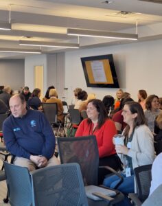 Attendees engage in conversation in small circles during a networking exercise at the Finding Abundance symposium.