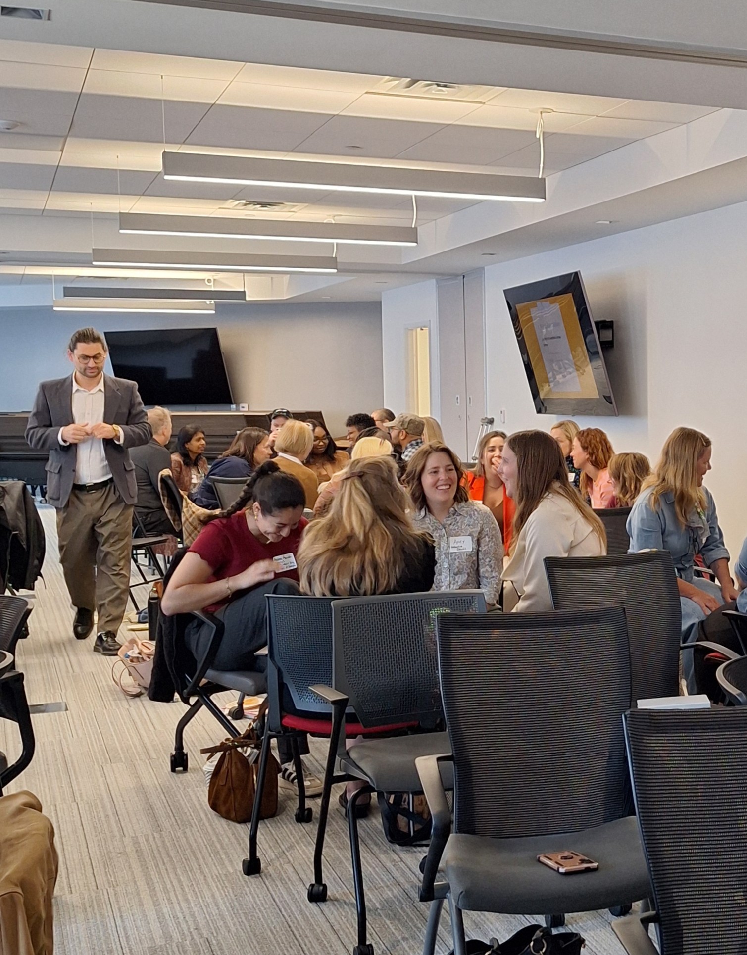 Attendees engage in conversation in small circles during a networking exercise at the Finding Abundance symposium.